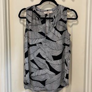Black and white sleeveless print top with v-neck that can also clasp at top